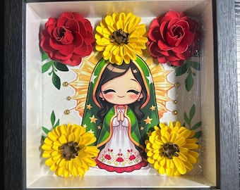 May include: A framed artwork featuring a cartoon depiction of a religious figure with a green and white robe, surrounded by red roses and yellow flowers. The artwork is set against a glittery background.