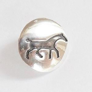 May include: A silver charm featuring a horse silhouette design.