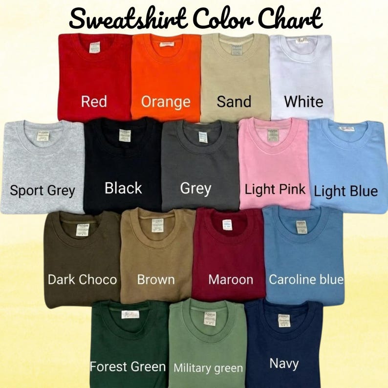 May include: A sweatshirt color chart displaying fifteen folded crewneck sweatshirts in various colors including red, orange, sand, white, sport grey, black, grey, light pink, light blue, dark choco, brown, maroon, caroline blue, forest green, military green, and navy.