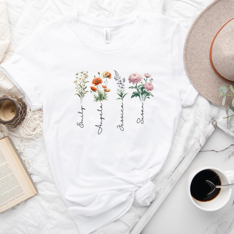 a white t - shirt with three flowers on it
