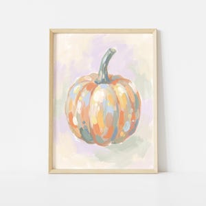 May include: A framed art print featuring a painterly pumpkin in shades of orange, yellow, blue, and green. The pumpkin has a prominent stem and is set against a soft, abstract background of muted lavender, cream, and light green brushstrokes.