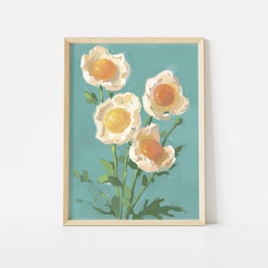 May include: A framed floral art print featuring a bouquet of flowers with white petals and orange centers against a teal background. The painting has a soft, brushstroke style, with green stems and leaves.