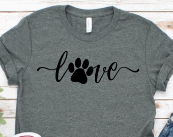 May include: A heather grey t-shirt with a black paw print and the word "love" in a cursive font.