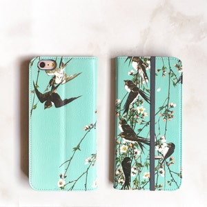 Funda tipo cartera para iPhone 14 con pájaros en las ramas. Cartera para iPhone 13, 12 y 11. Funda para mujer con flores de cerezo y golondrinas. Funda WC-BOB para iPhone 11.