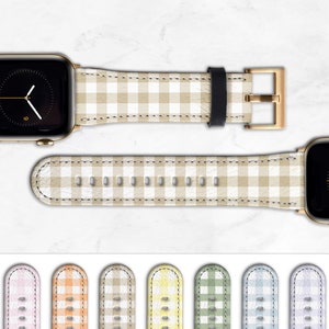 May include: A set of ten Apple Watch bands featuring a gingham pattern in a variety of colours. The bands are made from leather and have a gold buckle.