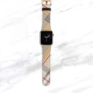 Designer plaid band for Apple Watch 41mm 40mm 38mm in camel, tan, beige, black and red colors. Large Nova Check pattern is on the diagonal on a faux Leather strap with gold hardware.
