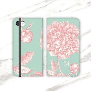 Funda personalizada para iPhone con peonía rosa sobre aguamarina. Cartera floral para iPhone 12, 16 y iPhone 14+. Monograma WC-PEOAQ