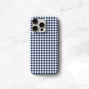Pu&ograve; includere: Una custodia per telefono con motivo a quadretti blu navy e bianco. La custodia ha un design a guscio rigido e presenta un ritaglio per la fotocamera. La custodia &egrave; progettata per adattarsi a uno smartphone.