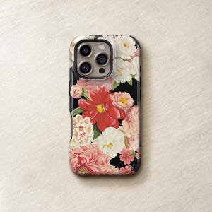 a phone case with a floral design, including red and white flowers, on a white background.