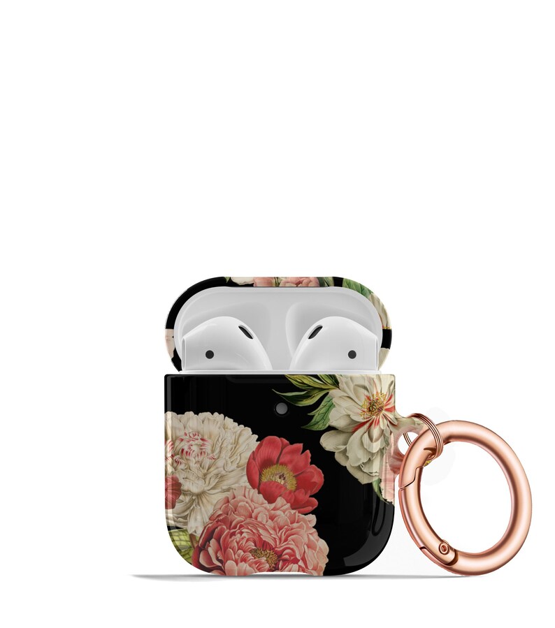 May include: A black Airpods case with a floral print featuring pink, white, and red flowers. The case has a rose gold carabiner clip.