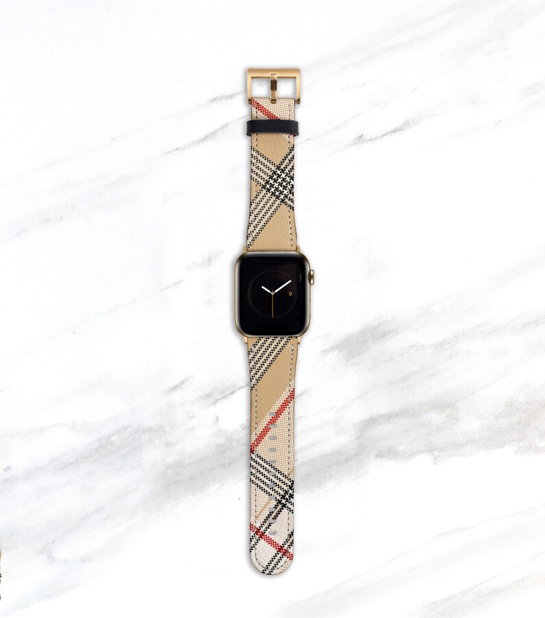Designer plaid band for Apple Watch 41mm 40mm 38mm in camel, tan, beige, black and red colors. Large Nova Check pattern is on the diagonal on a faux Leather strap with gold hardware.