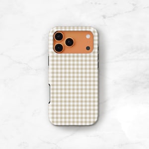 May include: A phone case with a tan and white gingham pattern. The case has a camera cutout with three lenses and a flash. The case is made of a hard plastic material and has a smooth finish.