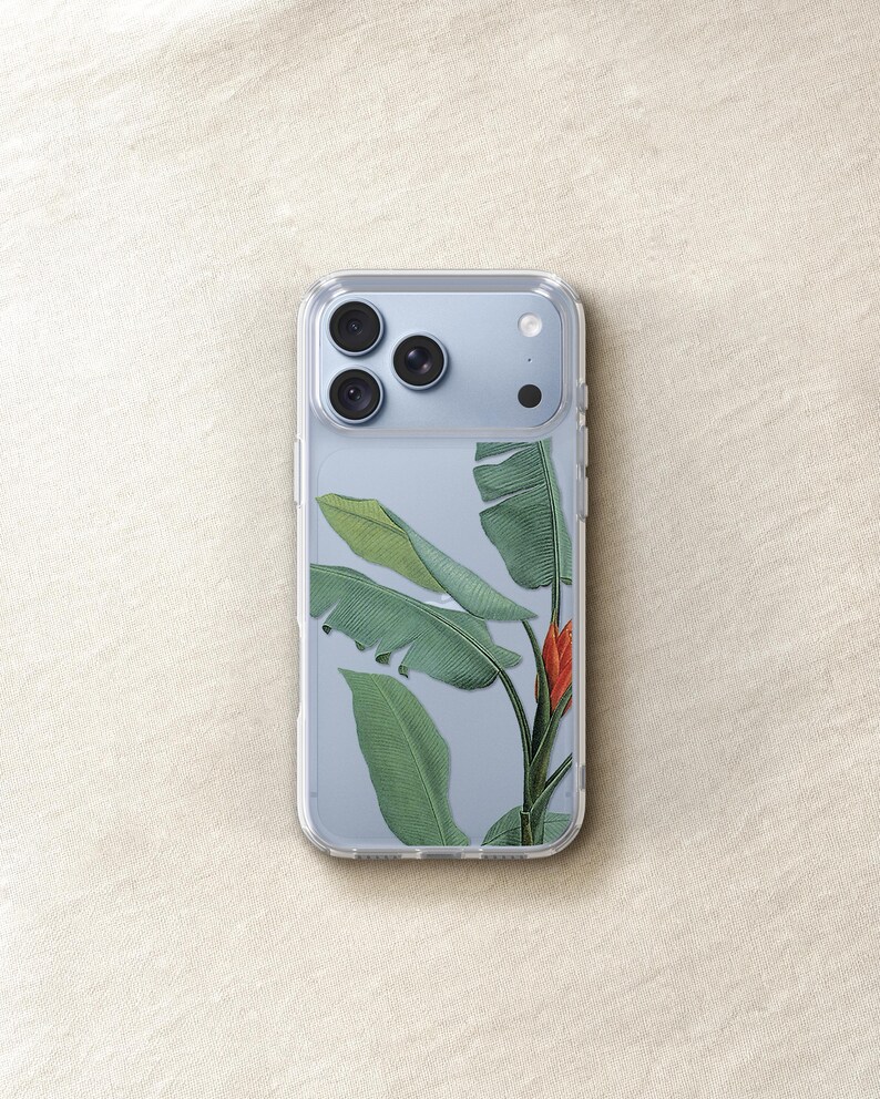 a clear phone case with a design of green leaves and a red flower on it.
