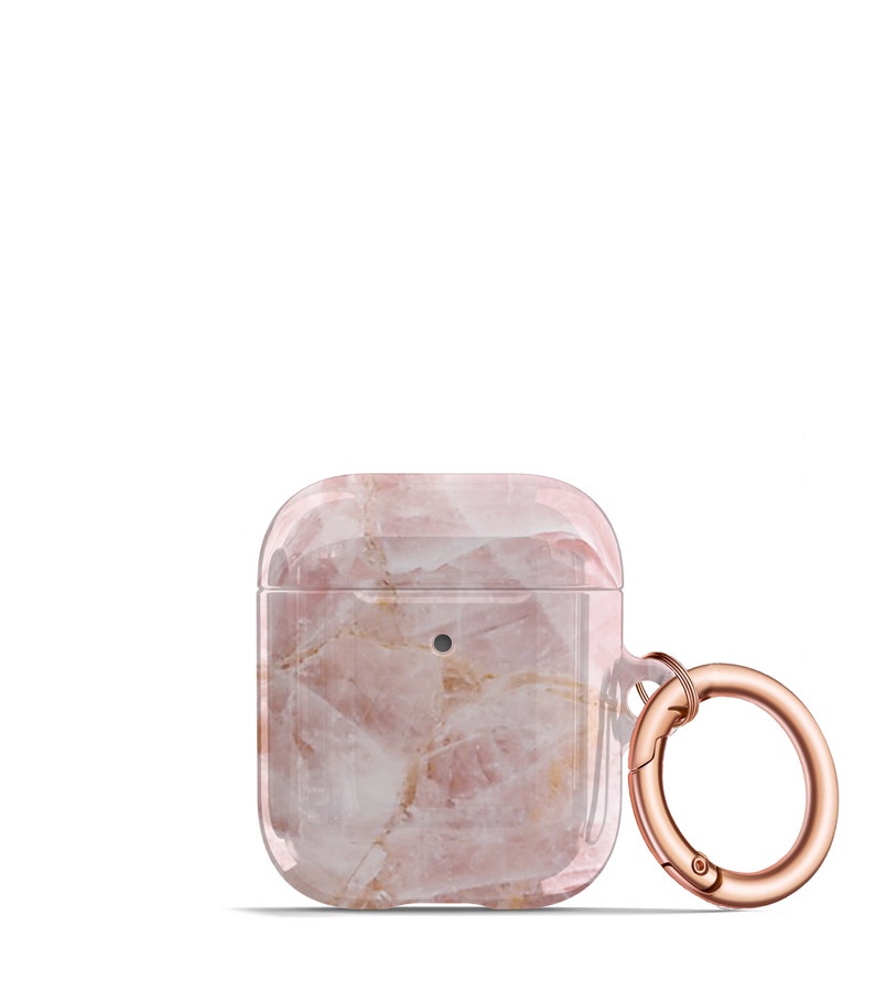 May include: A clear pink and white marble patterned phone case with a rose gold metal ring and clasp.