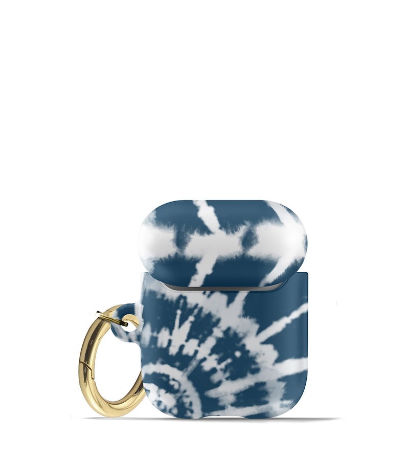 May include: A blue and white tie-dye Airpods case with a gold metal ring.