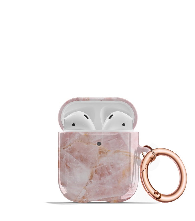 May include: A pink marble AirPods case with a rose gold carabiner clip. The case is open, revealing the white AirPods inside.
