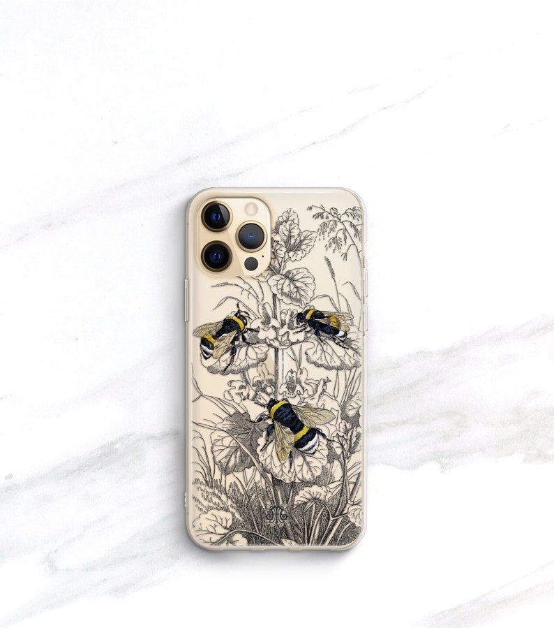 May include: A clear phone case with a black and white illustration of bees and flowers. The case has a gold trim around the camera lenses.