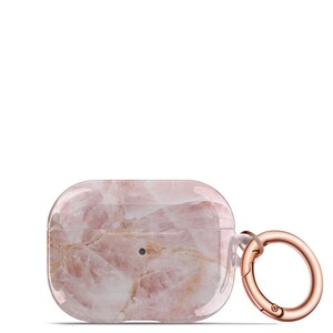 May include: A pink and white marble-patterned protective case for AirPods with a rose gold metal carabiner.
