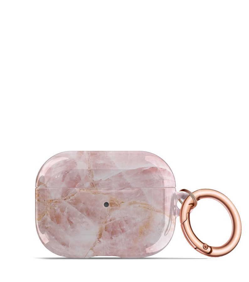 May include: A pink and white marble-patterned protective case for AirPods with a rose gold metal carabiner.
