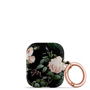 May include: Black Airpods case with a floral design featuring pink roses and green leaves. The case has a rose gold carabiner clip and the letter "m" in rose gold.