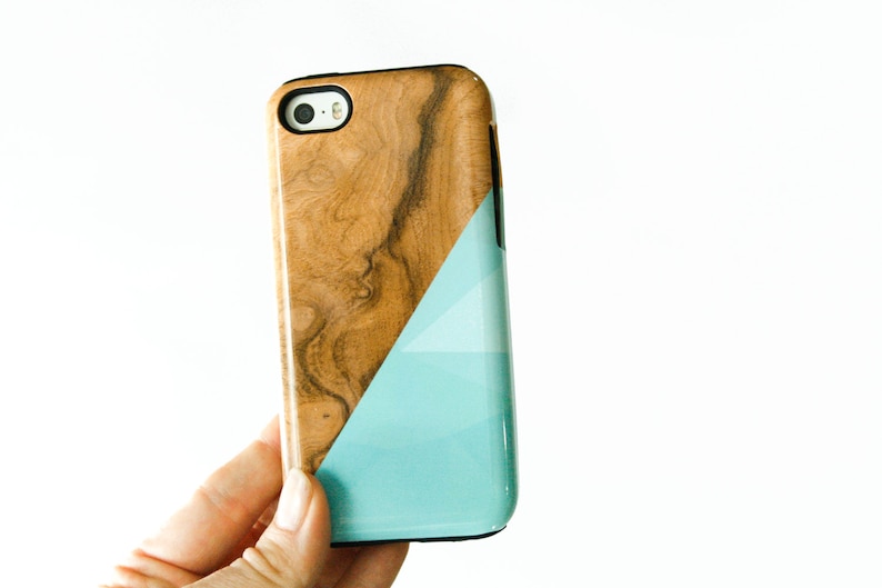 May include: A phone case made of wood and blue with a geometric design. The case is made from real wood and has a natural wood grain.