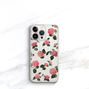 May include: A clear phone case with a floral design featuring pink and white camellias on a white background.