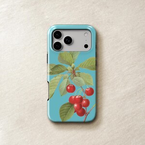 a phone case with a design of cherries and leaves on a blue background.