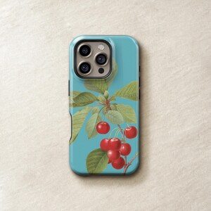 a phone case with a design of cherries and leaves on a blue background.