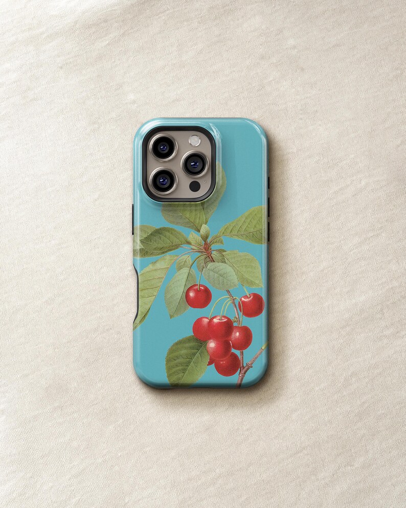 a phone case with a design of cherries and leaves on a blue background.