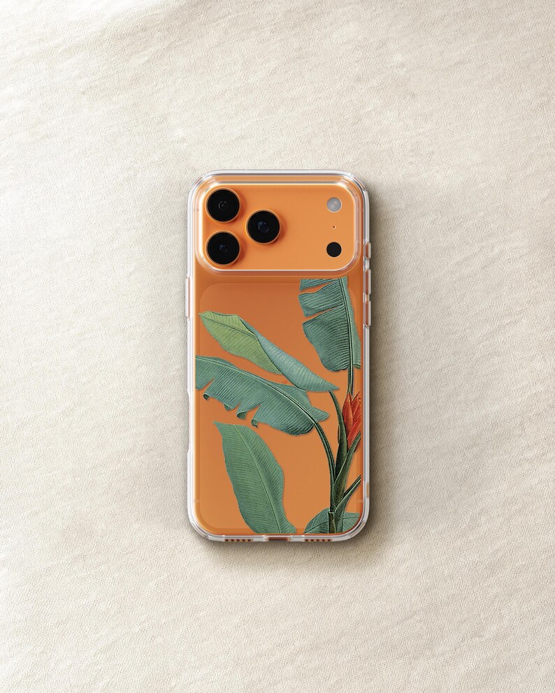 a clear phone case with a design of green leaves and a red flower on the back.