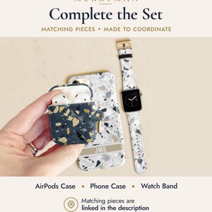 May include: A dark blue AirPods case with a gold and white terrazzo pattern, a white phone case with a grey and black terrazzo pattern featuring the text JMS, and a white watch band with a grey and black terrazzo pattern and a gold buckle.