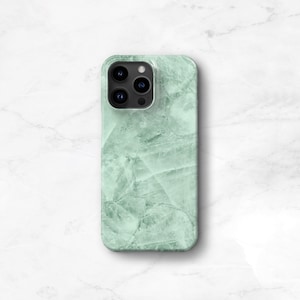May include: A green marble phone case with a camera lens cutout.