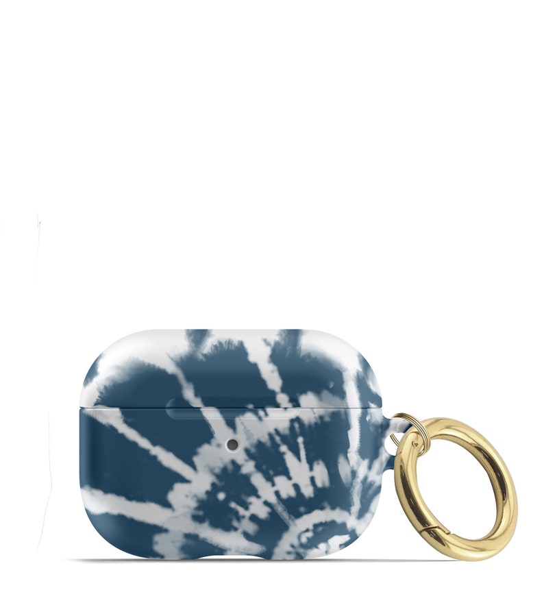 May include: A blue and white tie-dye patterned protective case for AirPods with a gold metal carabiner.
