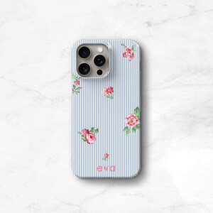 A blue and white seersucker striped phone case with delicate pink flowers personalized with the name 'eva' printed on the bottom. timeless East Coast prep