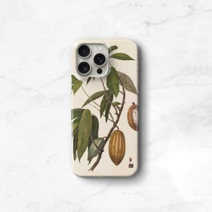 May include: A white phone case with a vintage illustration of a cocoa plant with green leaves and brown pods. The phone case has a clear back and a white border.