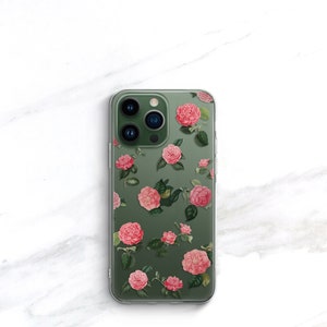 May include: A clear phone case with a floral design. The case features pink flowers with green leaves on a green background.