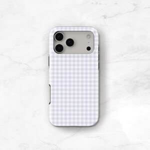 May include: A phone case with a light purple and white gingham pattern. The case has a rectangular shape with rounded corners and a camera cutout. The case is designed to fit a smartphone and protect it from scratches and damage.