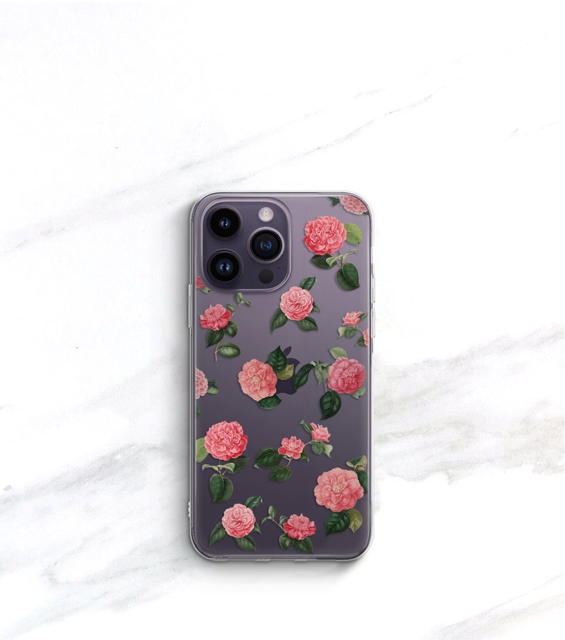 May include: A clear phone case with a floral design. The case features pink flowers with green leaves on a purple background.
