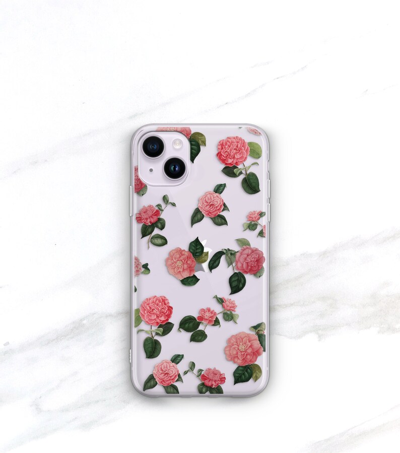May include: Clear phone case with a pink floral pattern. The case has a cutout for the camera lens.