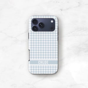 May include: A light blue and white gingham patterned phone case with the name "CHLOE" in white block letters. The case has a camera cutout and a dark blue camera module.