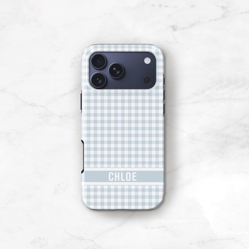 May include: A light blue and white gingham patterned phone case with the name "CHLOE" in white block letters. The case has a camera cutout and a dark blue camera module.