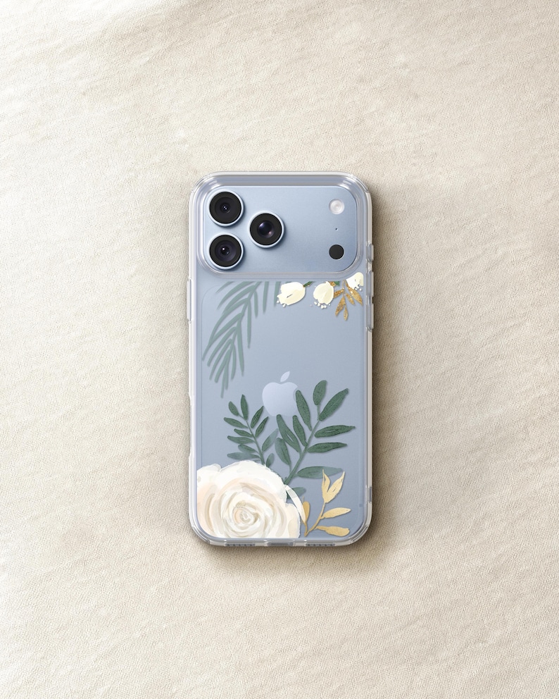 a clear iPhone case with a floral design featuring white roses and green leaves.