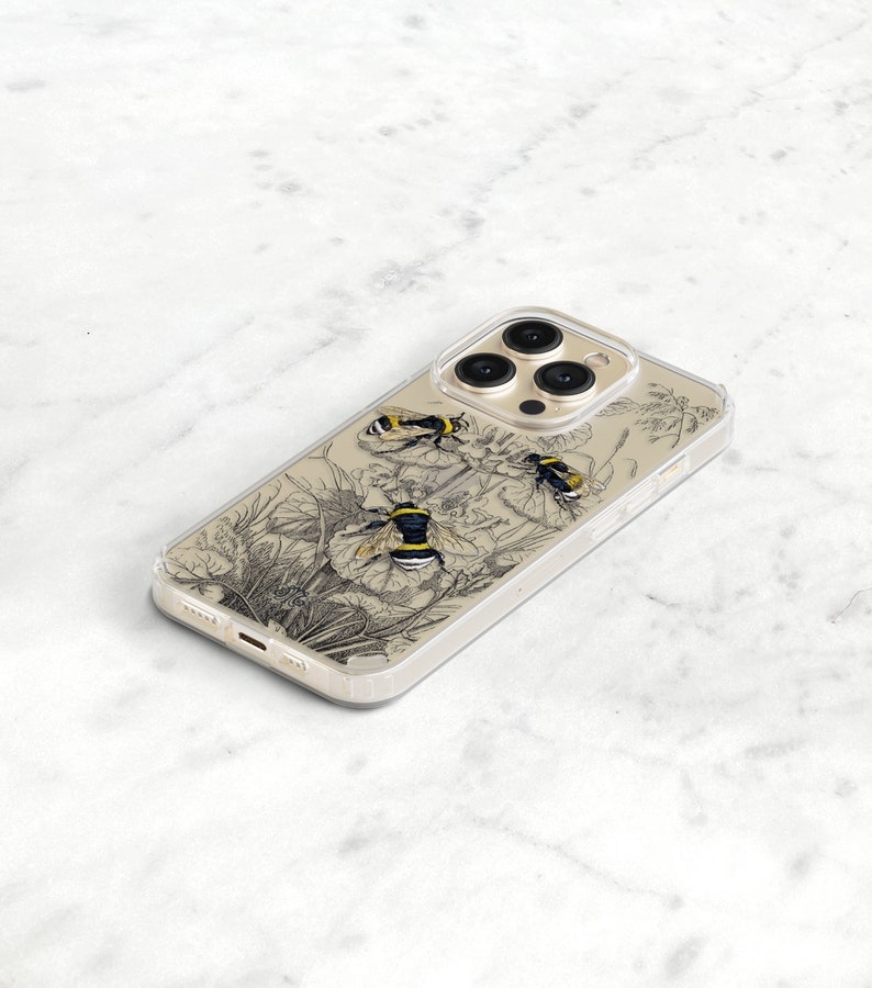 May include: A clear phone case with a black and white illustration of bees and flowers. The case is designed for an iPhone with a triple camera lens.