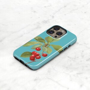 a blue phone case with a design of cherries and leaves on it.