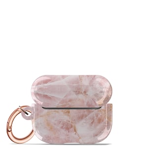 May include: A pink and white marble-patterned protective case for wireless earbuds with a rose gold carabiner clip.