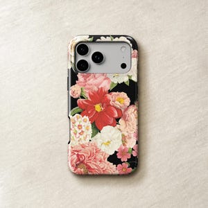 a phone case with a floral design, including pink and white flowers, against a light-colored background.
