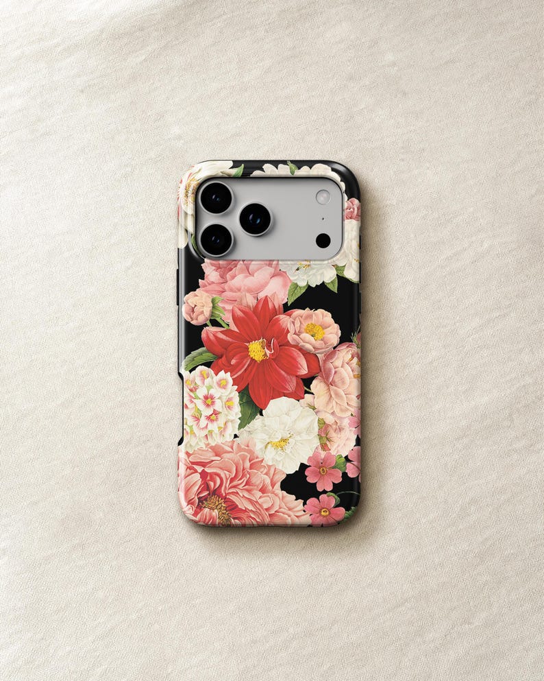 a phone case with a floral design, including pink and white flowers, against a light-colored background.