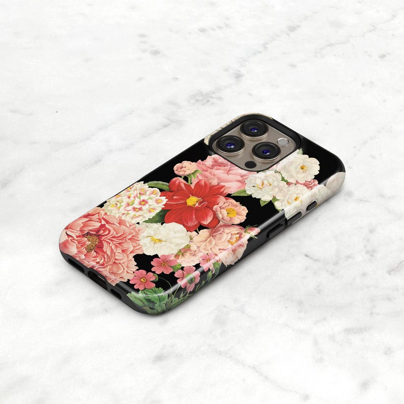 a smartphone case with a floral design on it, placed on a white marble surface.