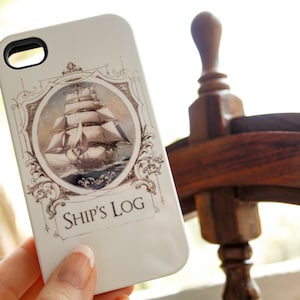 May include: A white iPhone case featuring a vintage illustration of a ship and the text "Ship's Log".
