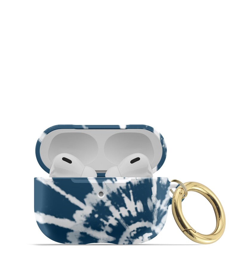 May include: A blue and white tie-dye patterned protective case for AirPods with a gold metal carabiner.